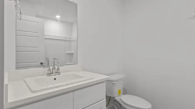 a bathroom with a sink a toilet and mirror