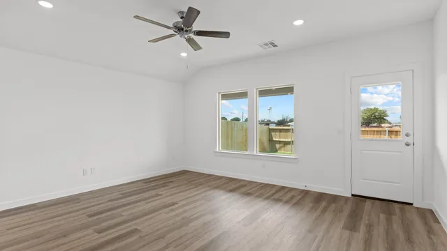 wooden floor in an empty room with a window