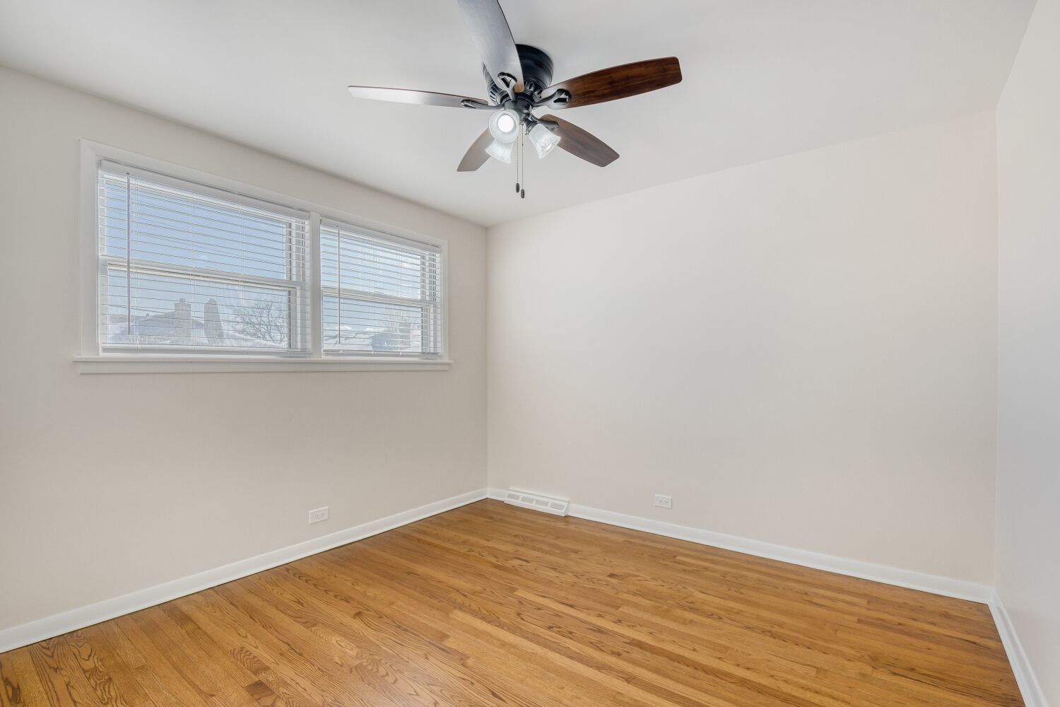 3643 West 113th Street Chicago, IL 60655 - Photo 13 of 19 an empty room with wooden floor and windows