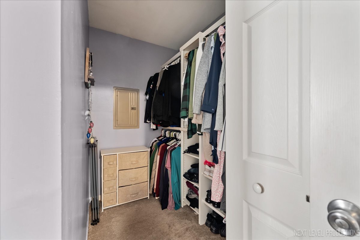 87 Saugatuck Road Montgomery, IL 60538 - Photo 11 of 27 a view of walk in closet with clothes