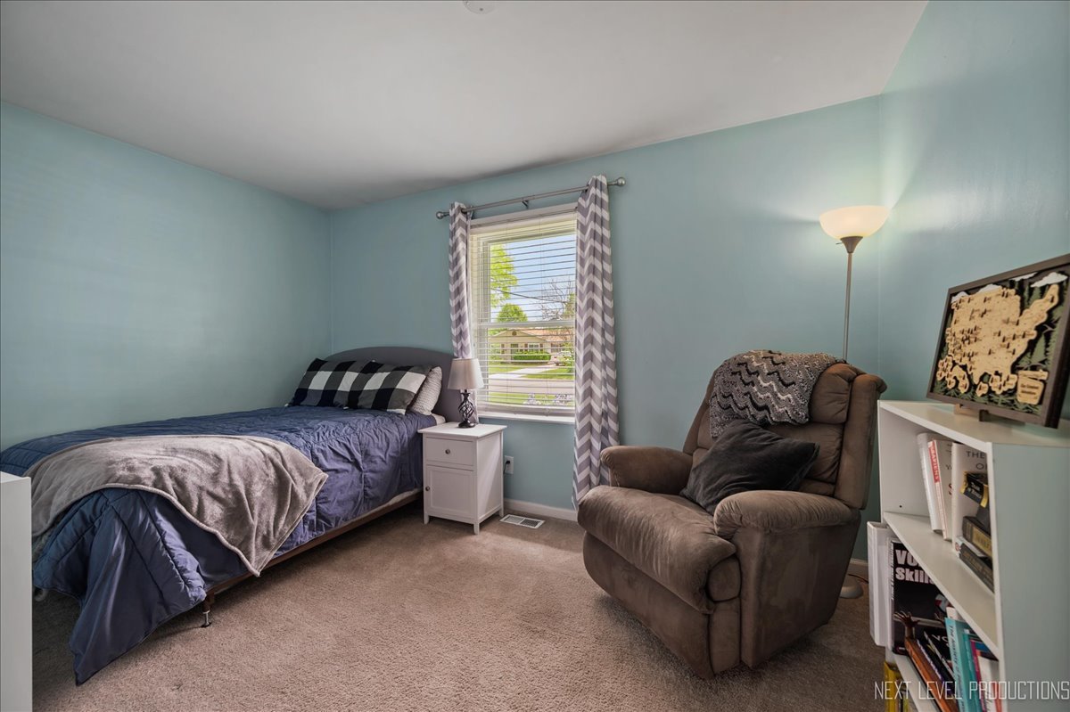 87 Saugatuck Road Montgomery, IL 60538 - Photo 13 of 27 a bedroom with bed and a window