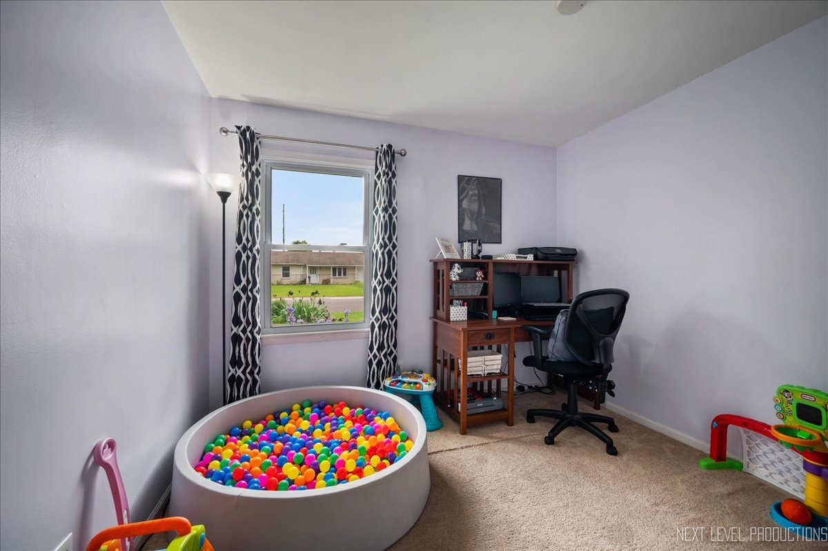 87 Saugatuck Road Montgomery, IL 60538 - Photo 17 of 27 a view of a workspace with furniture and a window
