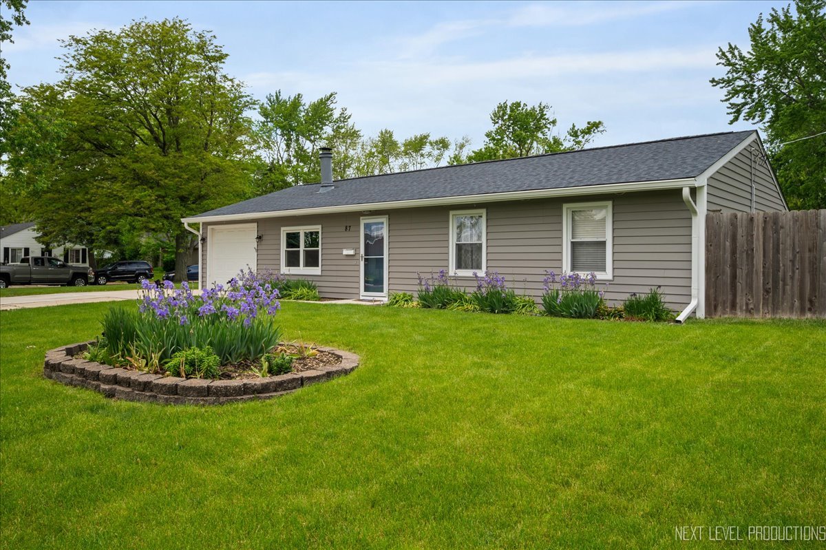 87 Saugatuck Road Montgomery, IL 60538 - Photo 27 of 27 a front view of a house with a yard and garage
