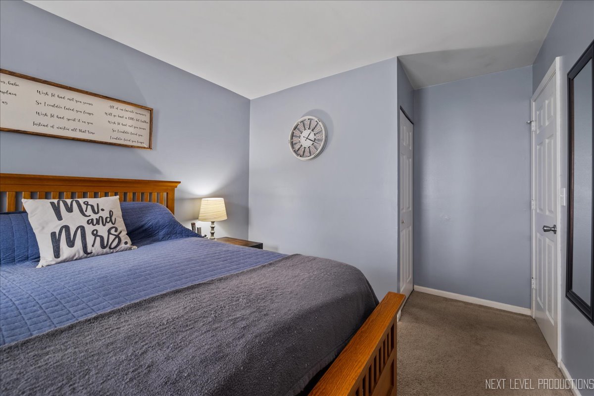 87 Saugatuck Road Montgomery, IL 60538 - Photo 10 of 27 a bedroom with a bed and a window