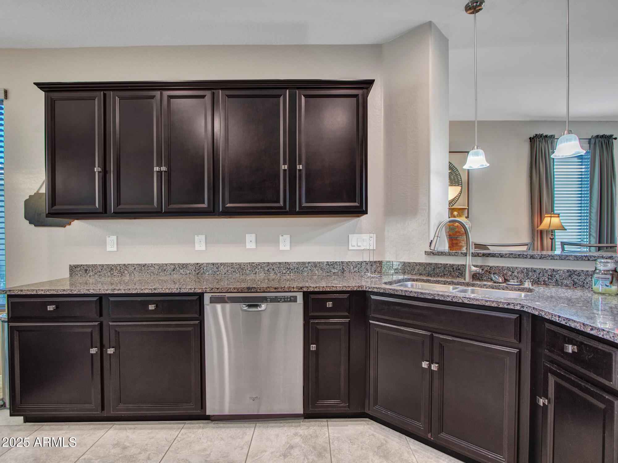 22585 West Moonlight Path Buckeye, AZ 85326 - Photo 13 of 35 a kitchen with stainless steel appliances granite countertop wooden cabinets and a granite counter tops