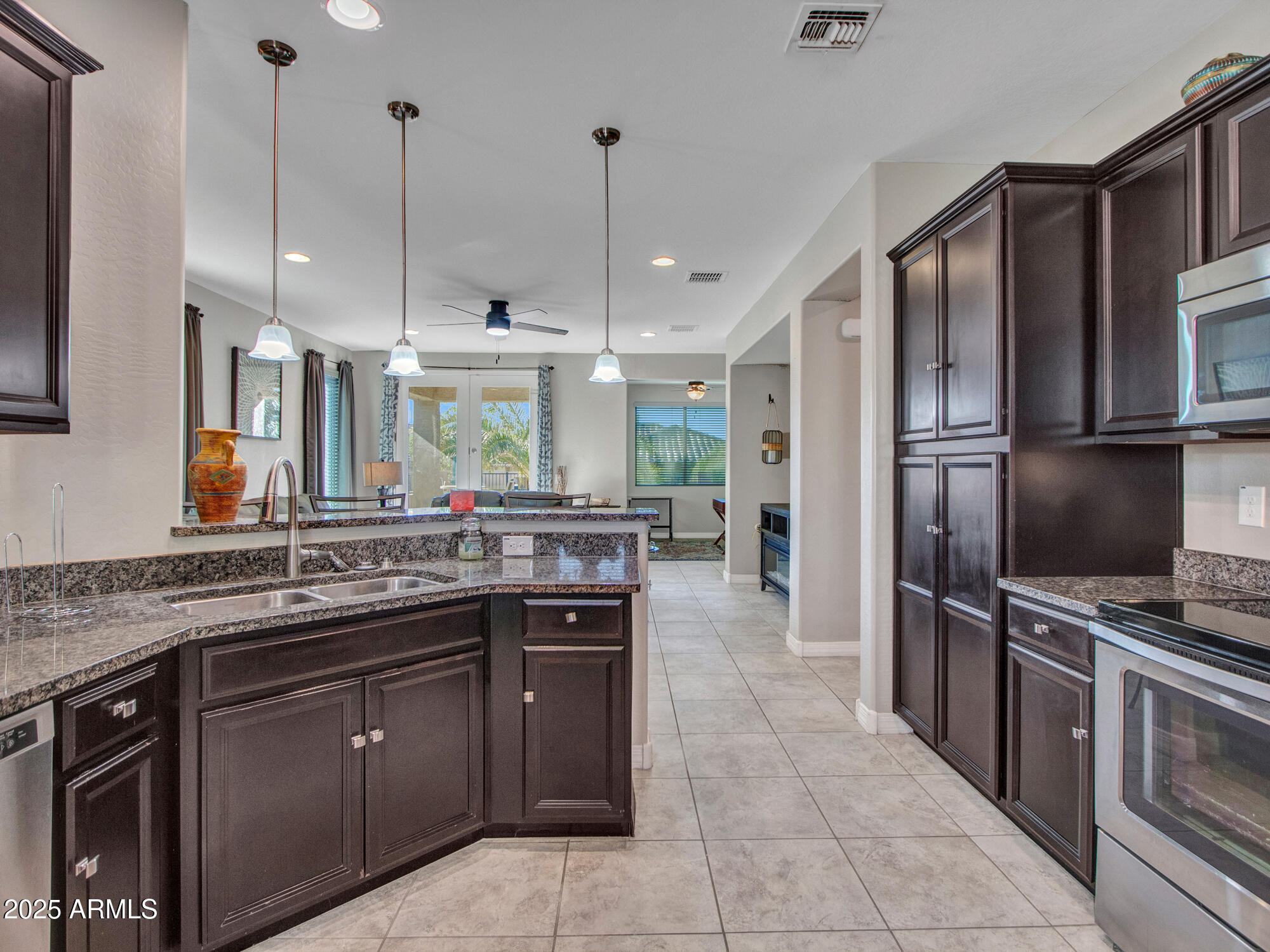 22585 West Moonlight Path Buckeye, AZ 85326 - Photo 14 of 35 a kitchen with a sink stove and refrigerator