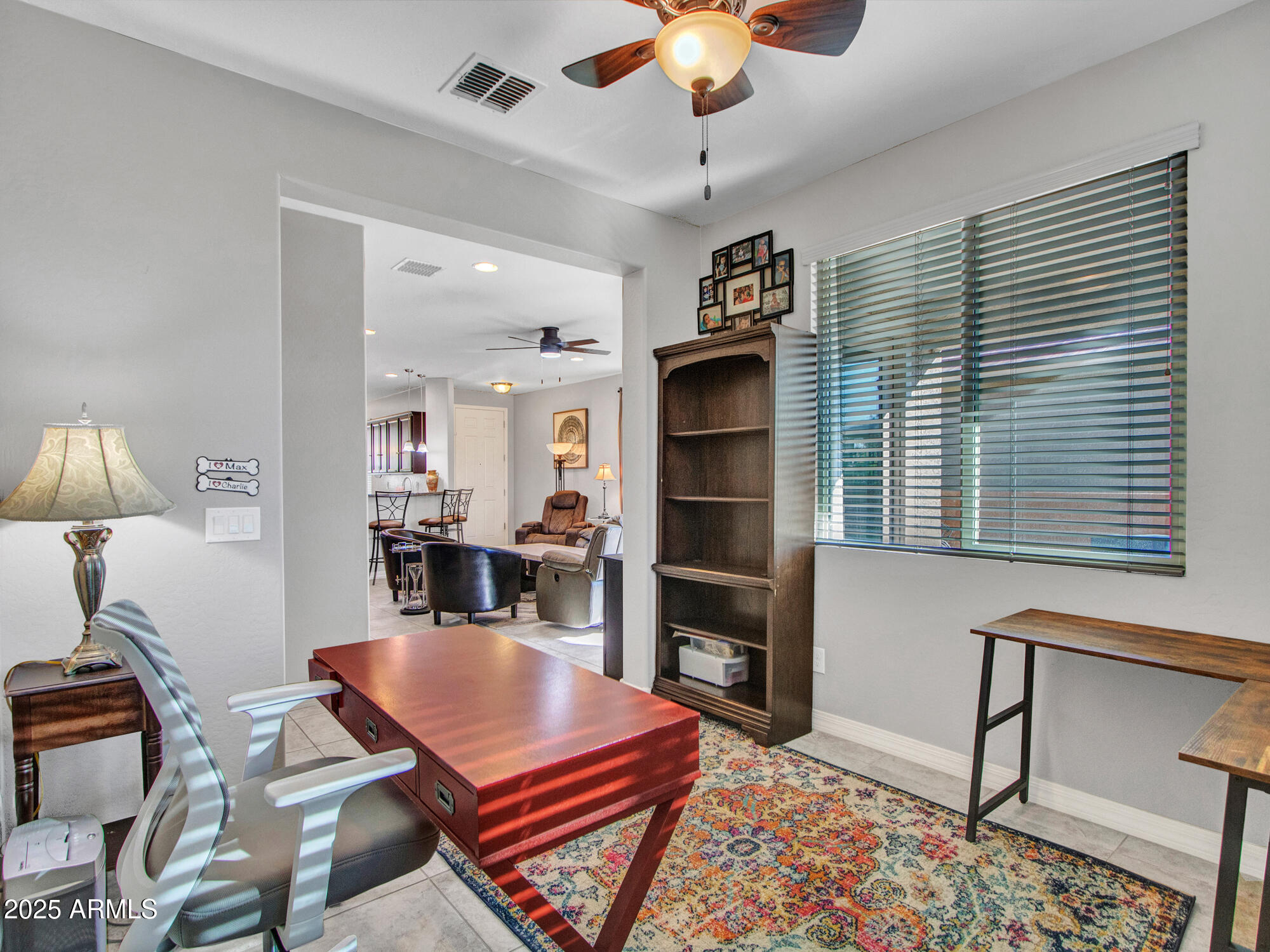 22585 West Moonlight Path Buckeye, AZ 85326 - Photo 18 of 35 a living room with furniture a chandelier and a flat screen tv