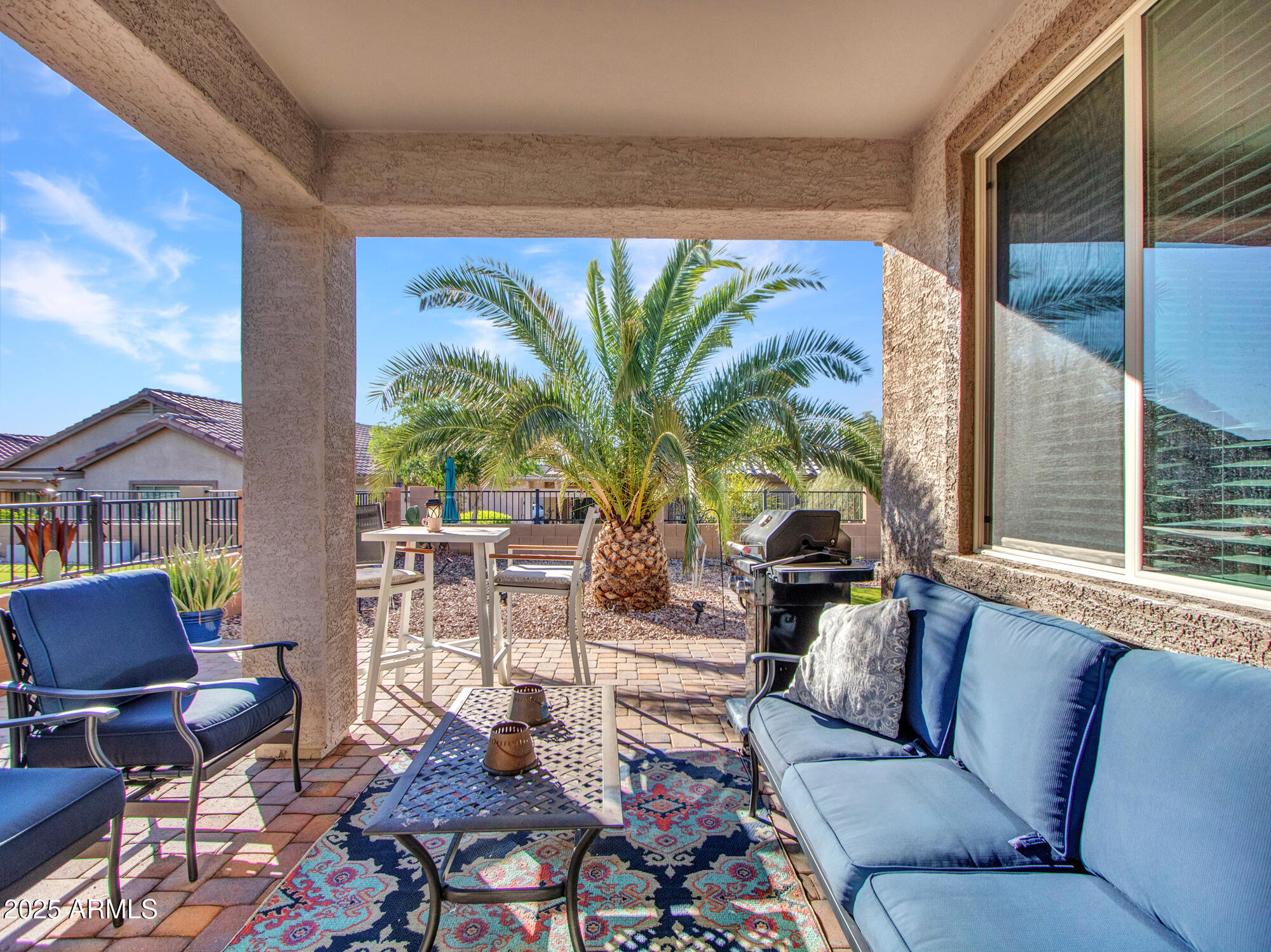 22585 West Moonlight Path Buckeye, AZ 85326 - Photo 19 of 35 a living room with furniture a floor to ceiling window and potted plants