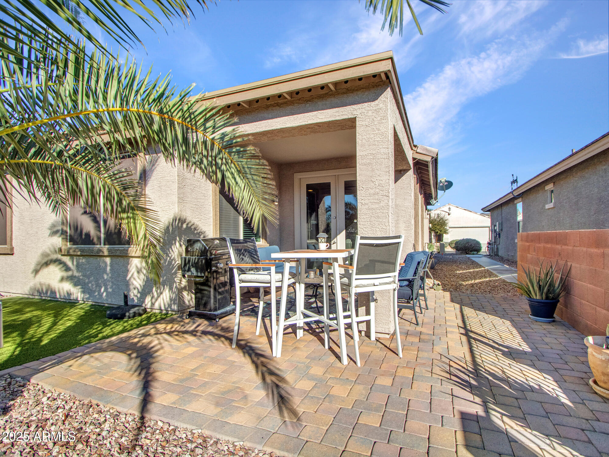 22585 West Moonlight Path Buckeye, AZ 85326 - Photo 22 of 35 a view of a patio with table and chairs potted plants and palm tree
