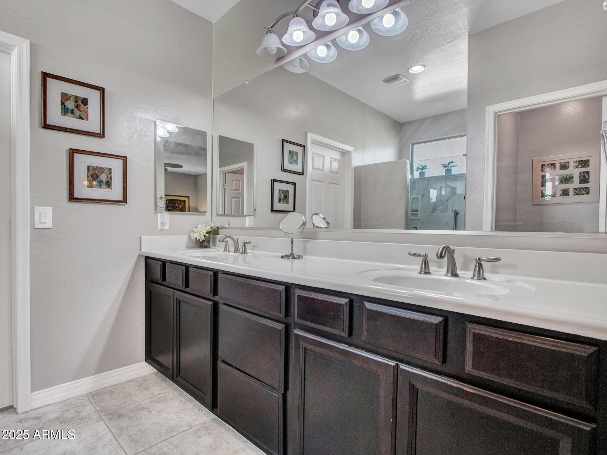22585 West Moonlight Path Buckeye, AZ 85326 - Photo 29 of 35 a bathroom with a sink a large mirror and a light fixture