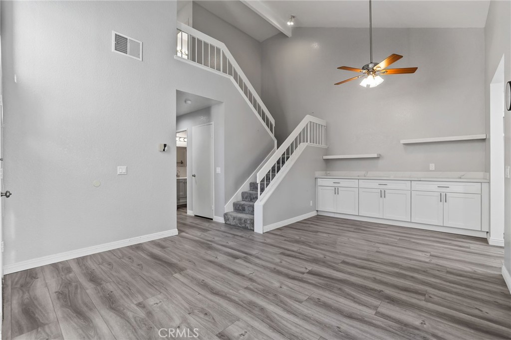 4 Gettysburg Irvine, CA 92620 - Photo 11 of 48 a view of an empty room with wooden floor and a ceiling fan