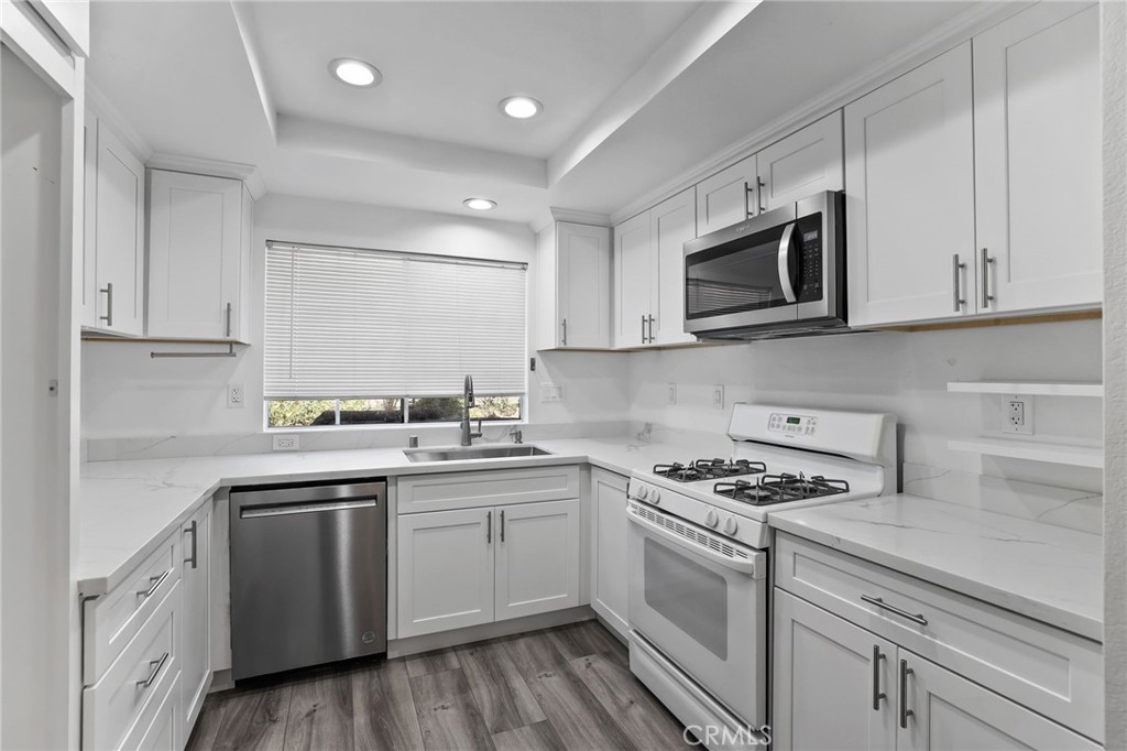 4 Gettysburg Irvine, CA 92620 - Photo 17 of 48 a kitchen with cabinets appliances a sink and a counter top space