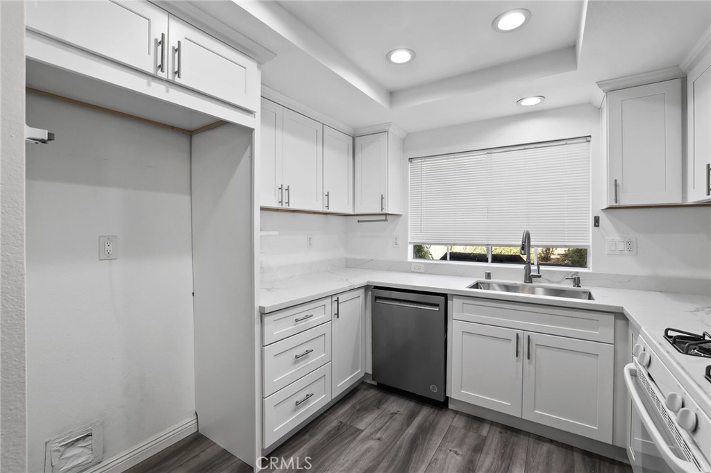 4 Gettysburg Irvine, CA 92620 - Photo 18 of 48 a kitchen with cabinets appliances a sink and a counter top space