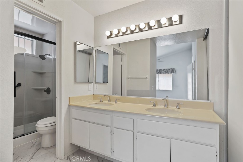 4 Gettysburg Irvine, CA 92620 - Photo 31 of 48 a bathroom with a double vanity sink mirror and toilet