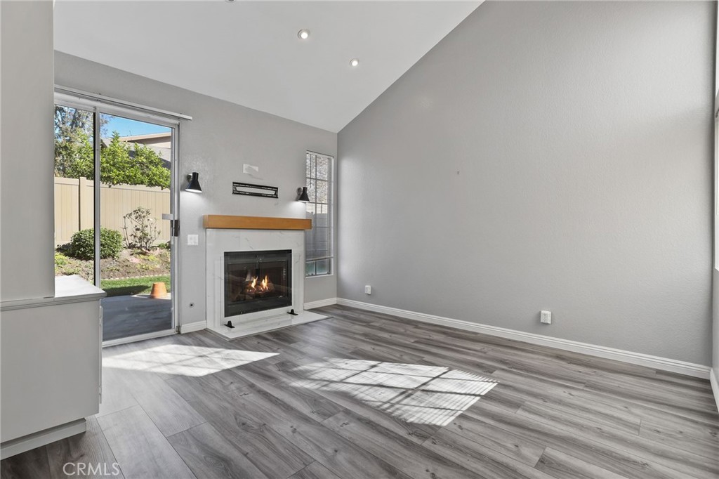 4 Gettysburg Irvine, CA 92620 - Photo 7 of 48 a view of empty room with wooden floor and fireplace