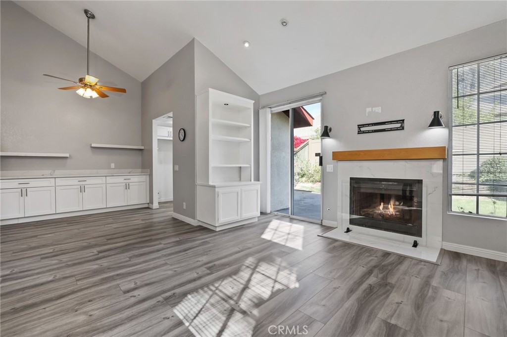 4 Gettysburg Irvine, CA 92620 - Photo 8 of 48 a view of a kitchen and an empty room with wooden floor and a fireplace