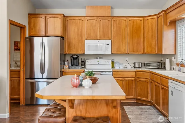 a kitchen with a refrigerator a sink and cabinets