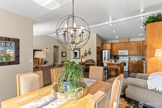 a view of a dining room with furniture a chandelier and wooden floor