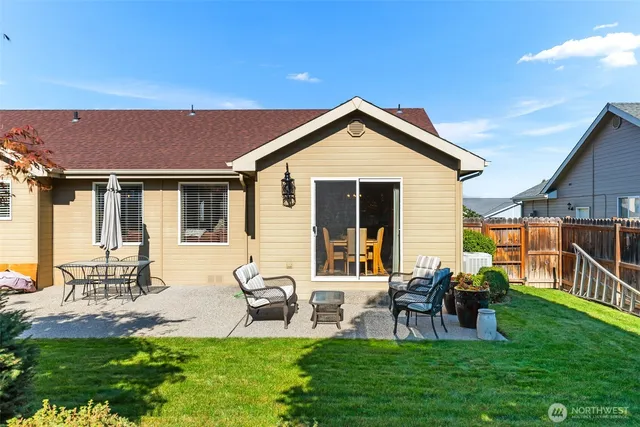 a front view of house with a garden and patio
