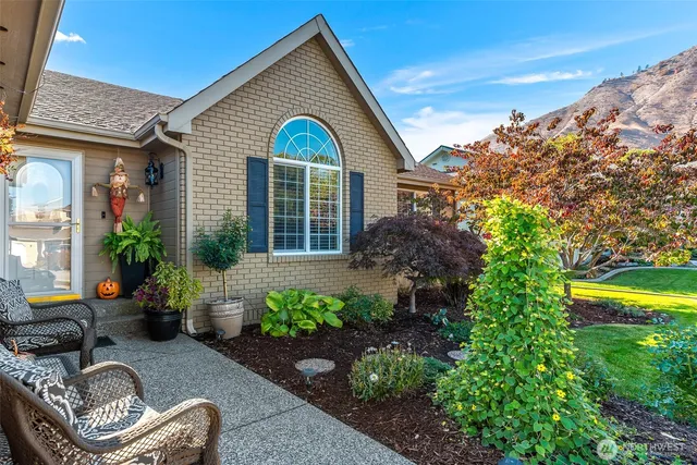 a view of a house with patio outdoor seating and plants