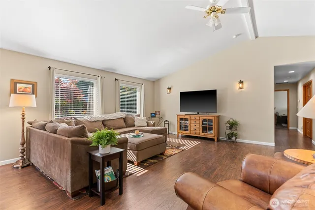 a living room with furniture flat screen tv and a fireplace