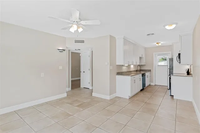 a view of kitchen with refrigerator and cabinets