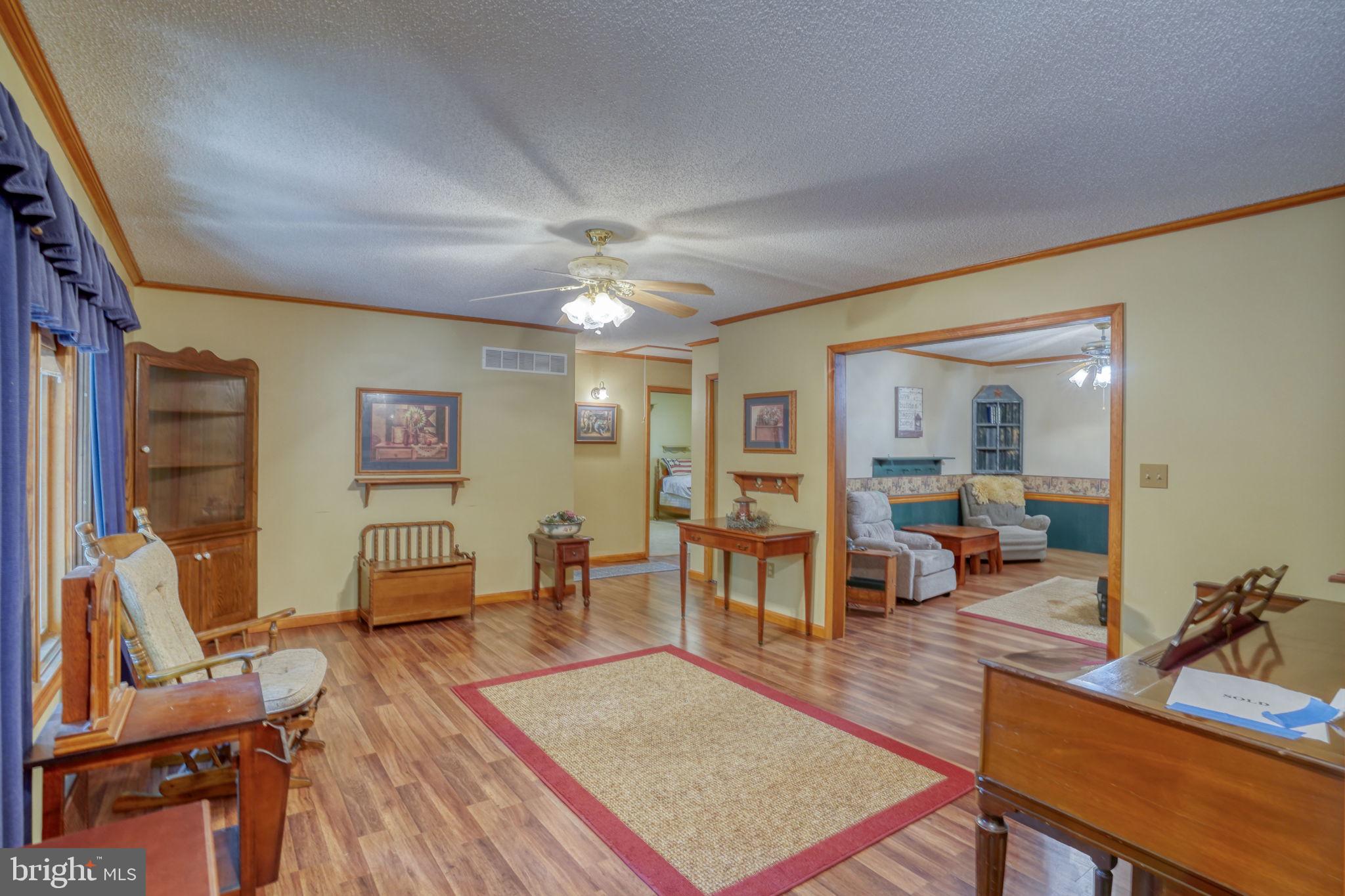 1332 Alley Mill Road Clayton, DE 19938 - Photo 14 of 50 a living room with furniture and a chandelier