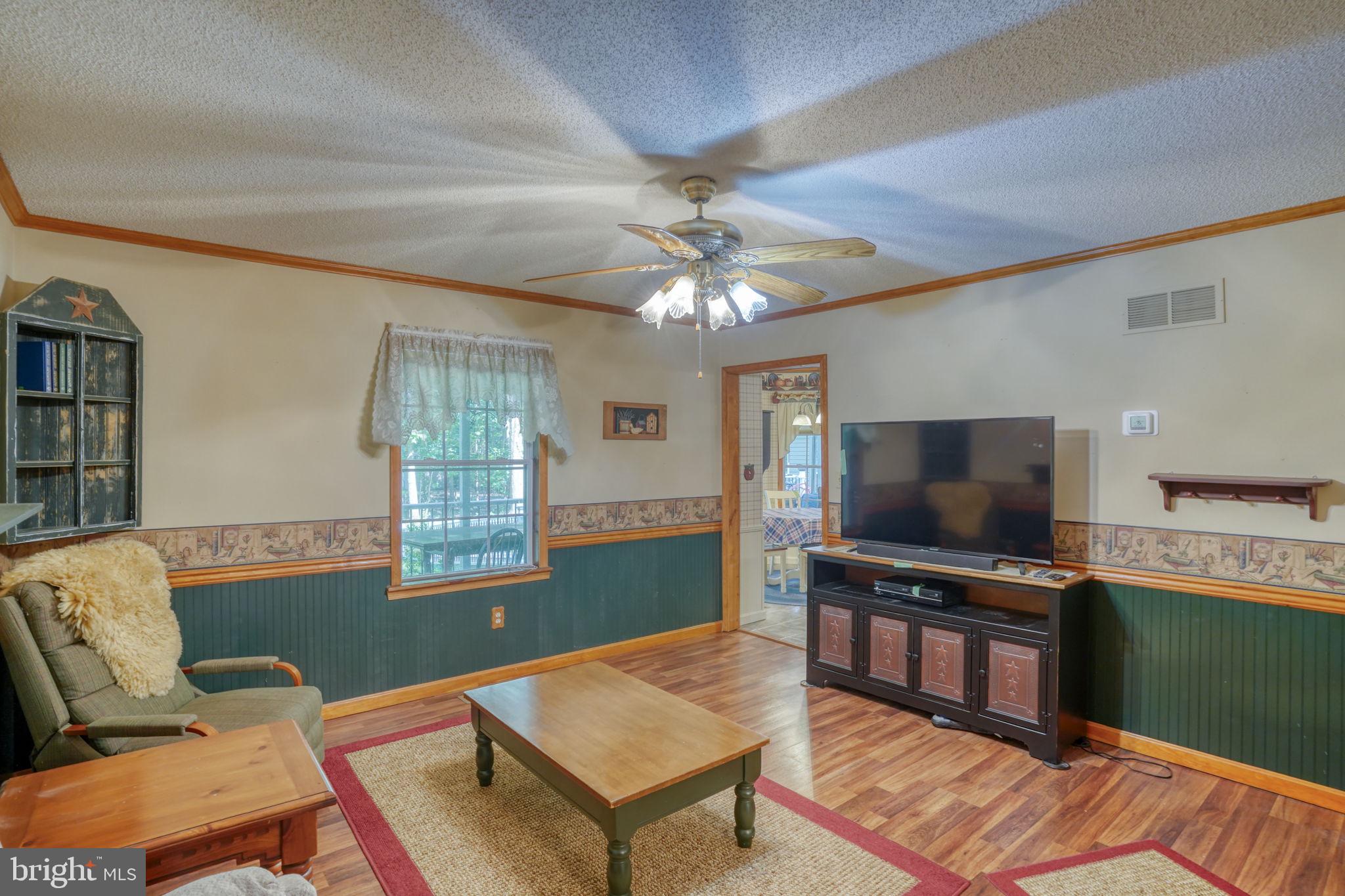 1332 Alley Mill Road Clayton, DE 19938 - Photo 16 of 50 a living room with furniture and a flat screen tv