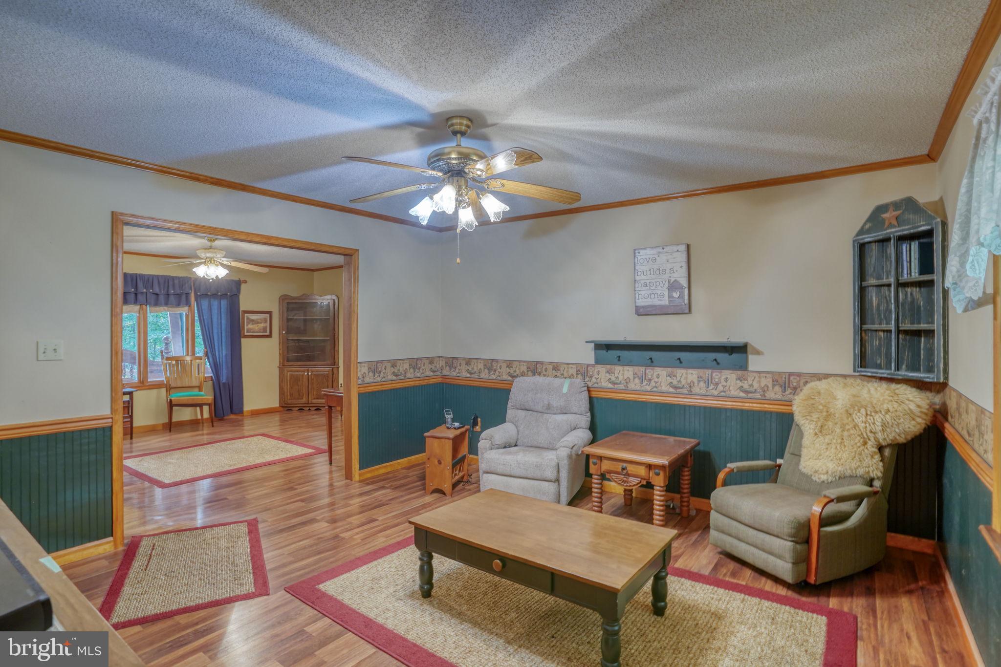 1332 Alley Mill Road Clayton, DE 19938 - Photo 18 of 50 a living room with furniture and a chandelier