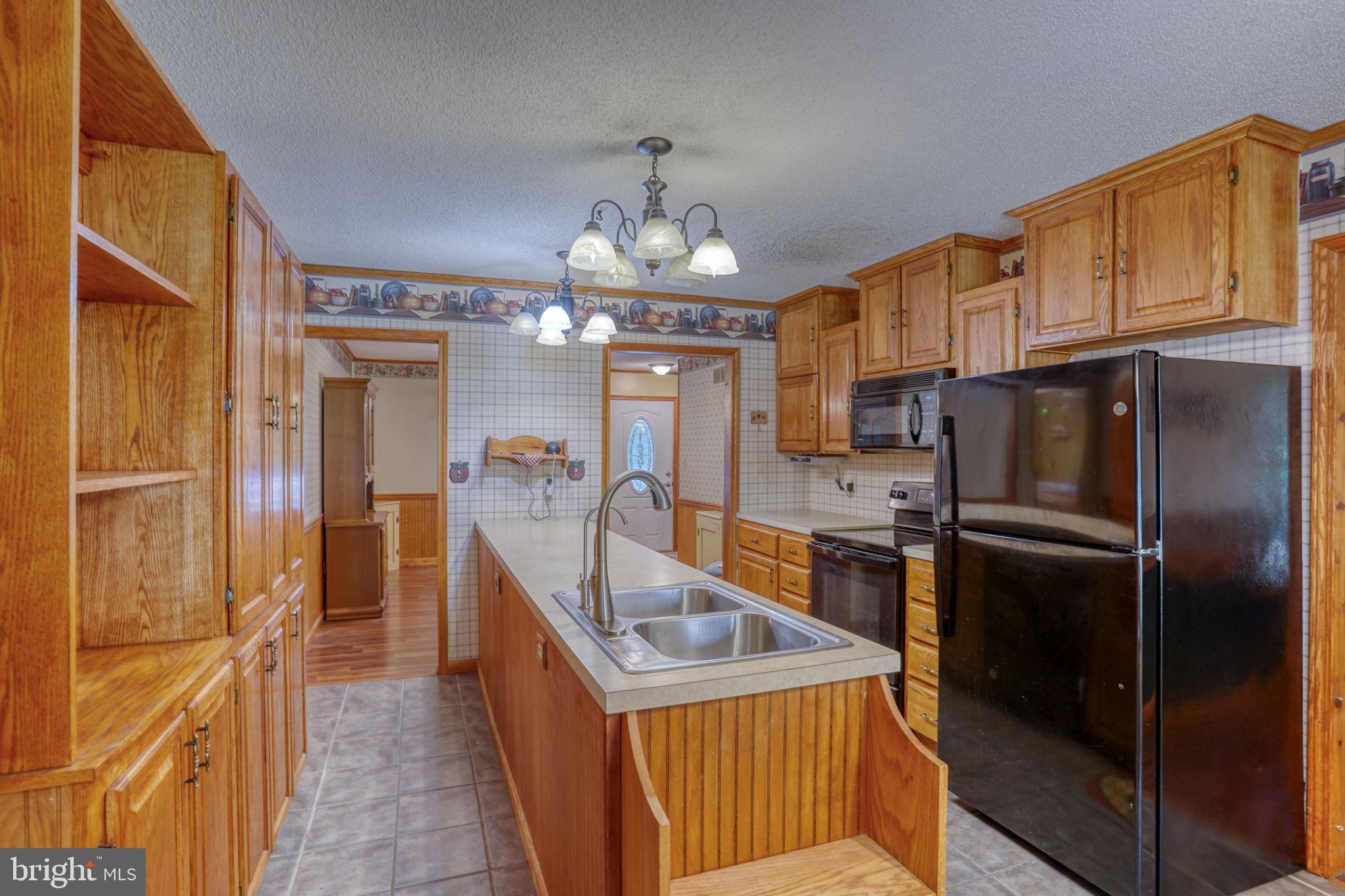 1332 Alley Mill Road Clayton, DE 19938 - Photo 22 of 50 a kitchen with granite countertop a refrigerator stove and sink