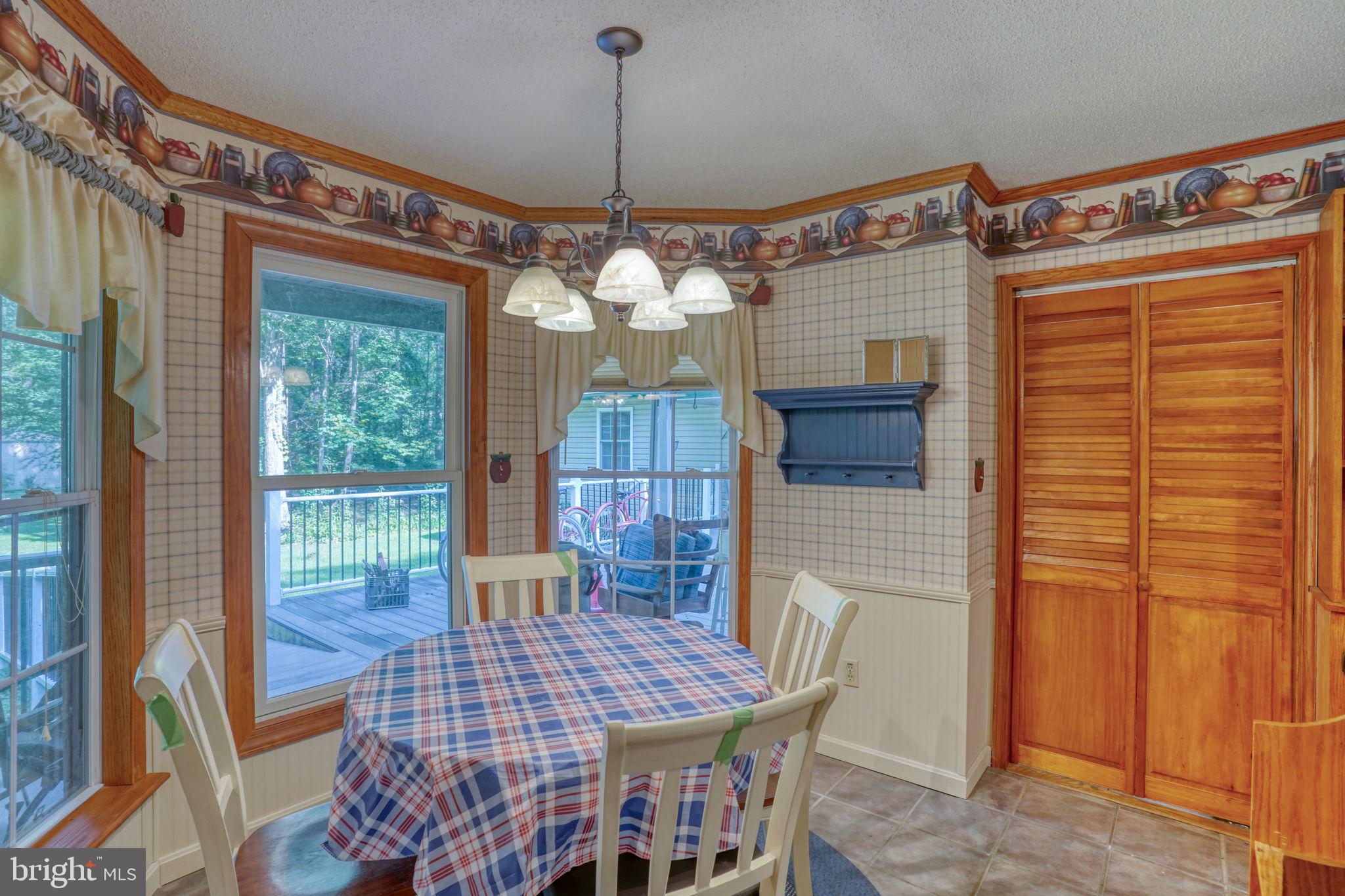 1332 Alley Mill Road Clayton, DE 19938 - Photo 26 of 50 a view of a dining room with furniture wooden floor and chandelier