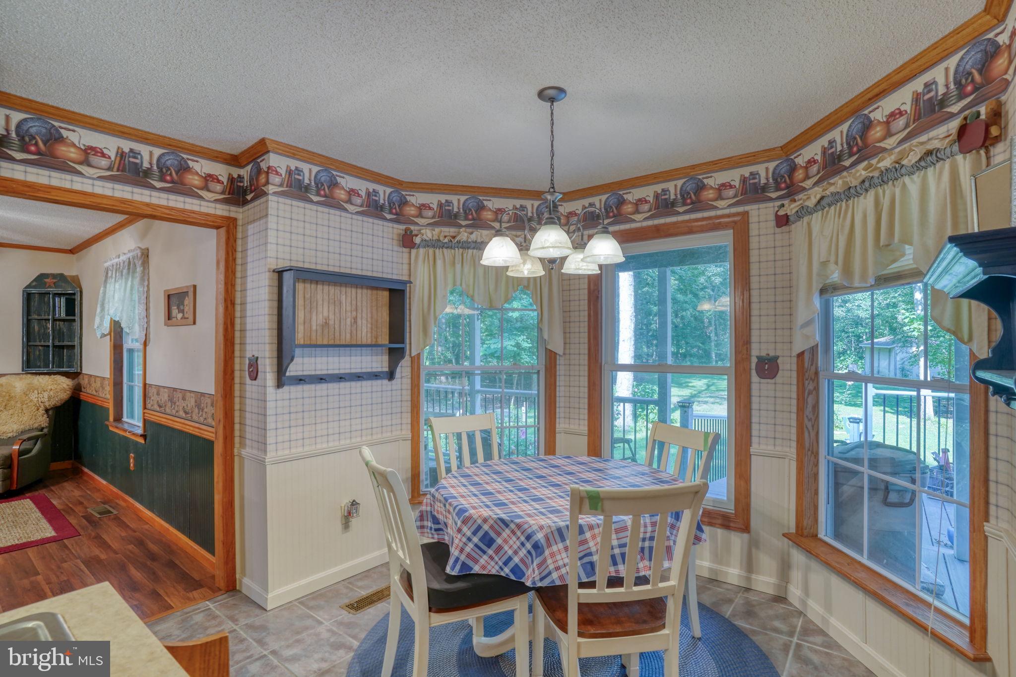 1332 Alley Mill Road Clayton, DE 19938 - Photo 27 of 50 a view of a dining room with furniture window and wooden floor