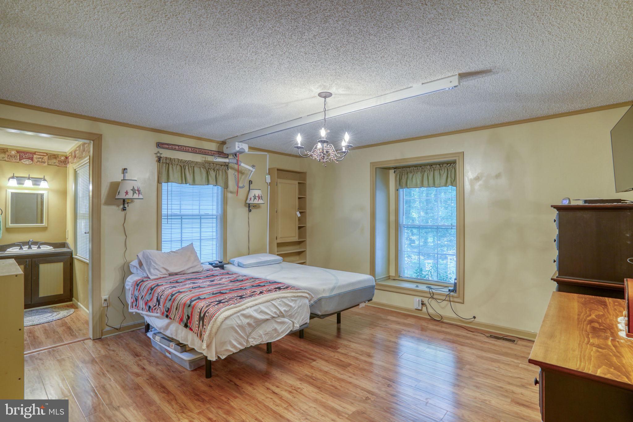 1332 Alley Mill Road Clayton, DE 19938 - Photo 28 of 50 a bedroom with a bed and a flat tv screen on dresser