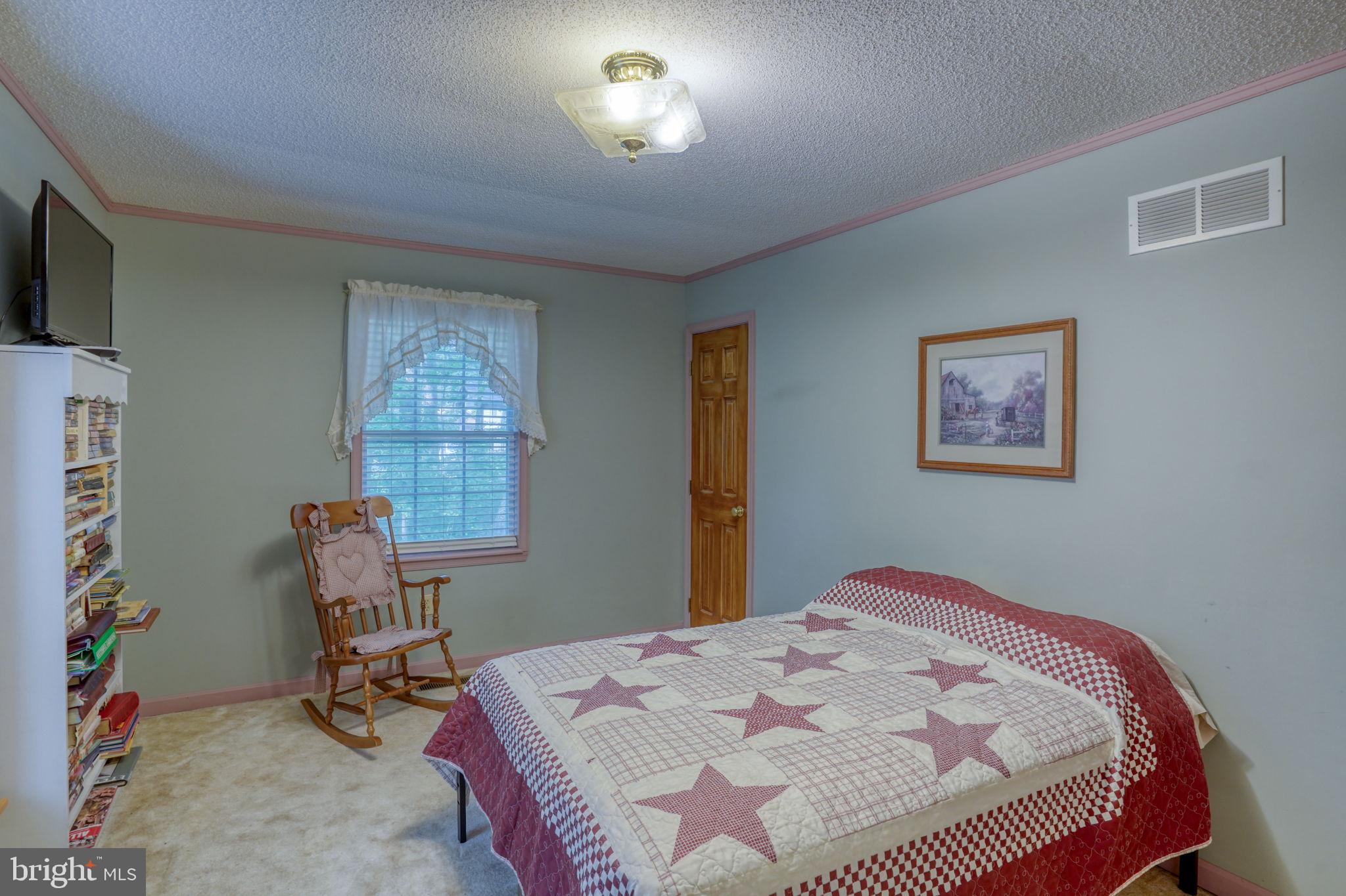 1332 Alley Mill Road Clayton, DE 19938 - Photo 33 of 50 a bedroom with a bed a desk and chair