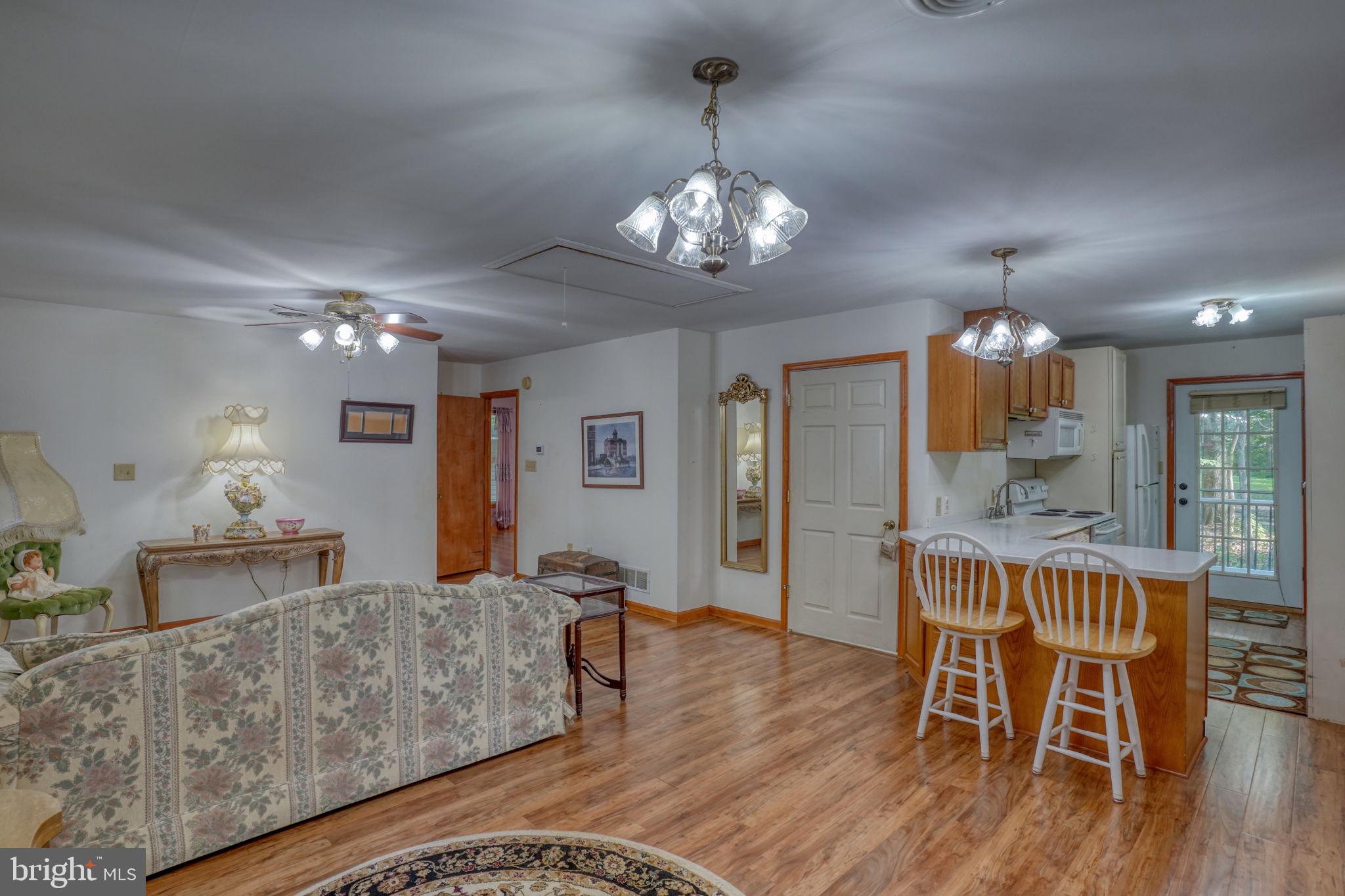 1332 Alley Mill Road Clayton, DE 19938 - Photo 38 of 50 a living room with furniture dining table and a chandelier