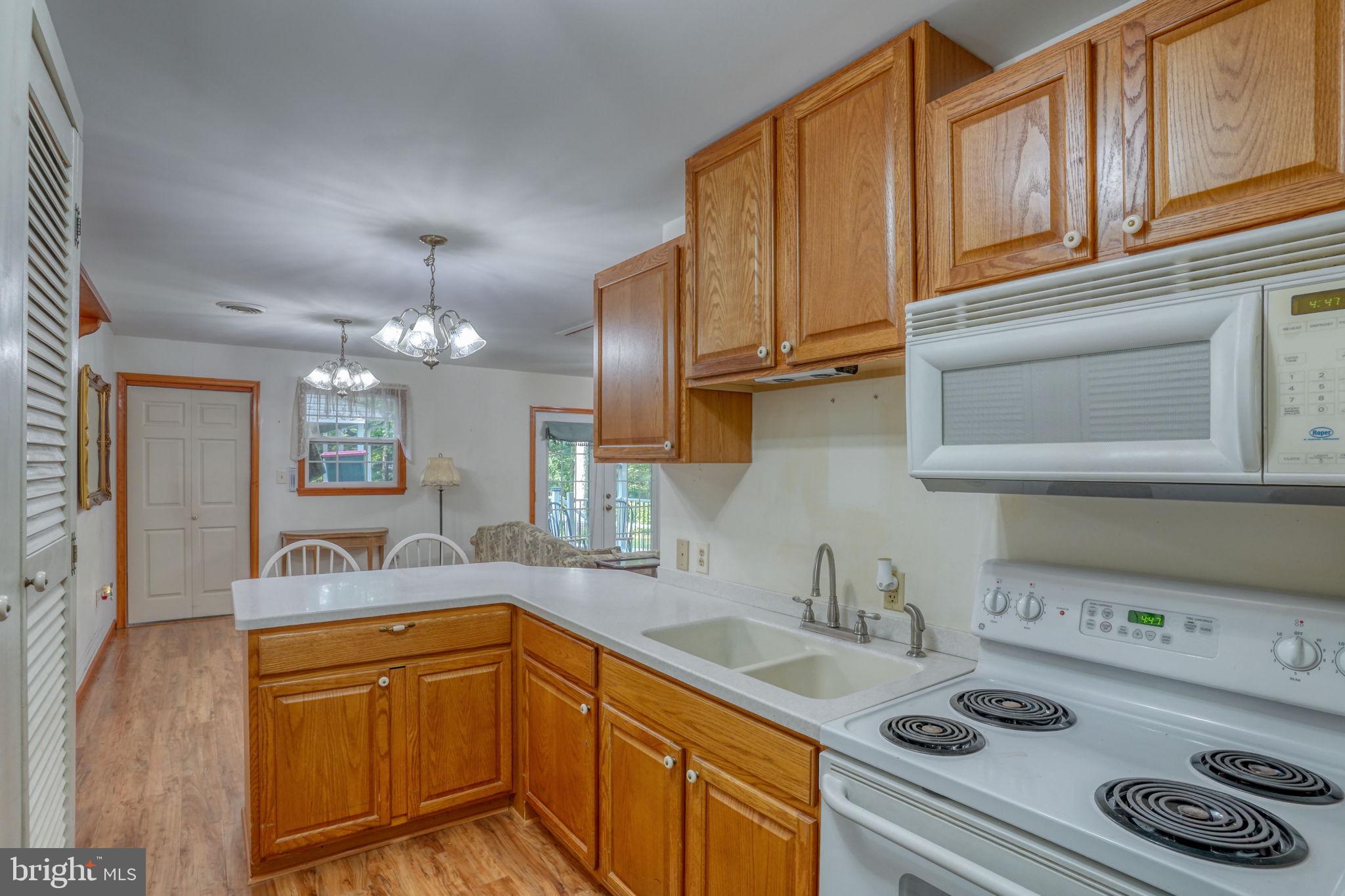 1332 Alley Mill Road Clayton, DE 19938 - Photo 43 of 50 a kitchen with kitchen island a sink stove and cabinets