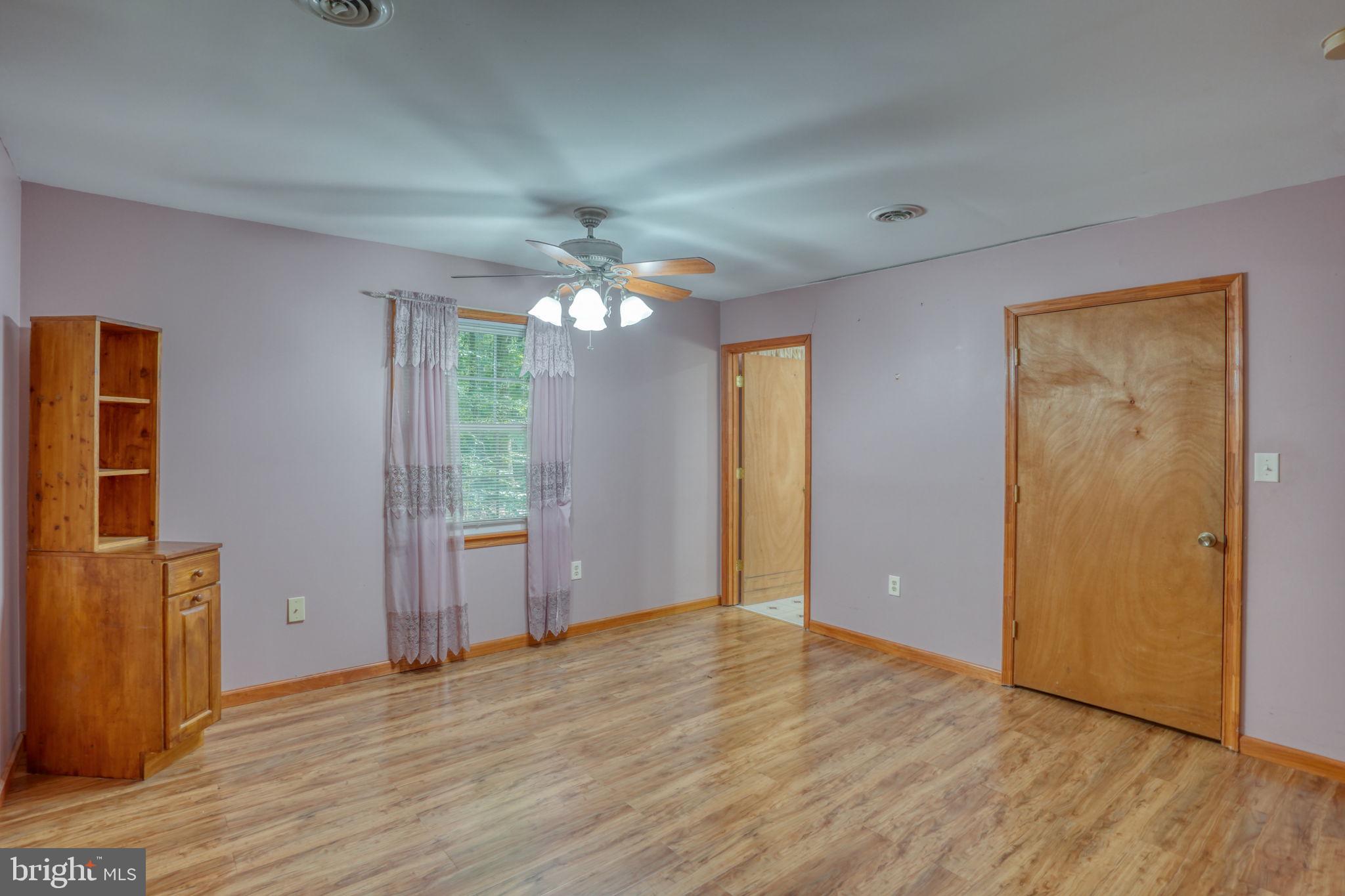 1332 Alley Mill Road Clayton, DE 19938 - Photo 48 of 50 a view of an empty room with wooden floor and a window