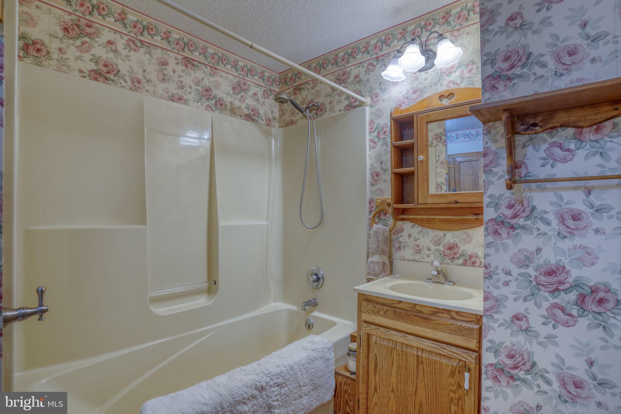 1332 Alley Mill Road Clayton, DE 19938 - Photo 50 of 50 a bathroom with a granite countertop sink a toilet and shower
