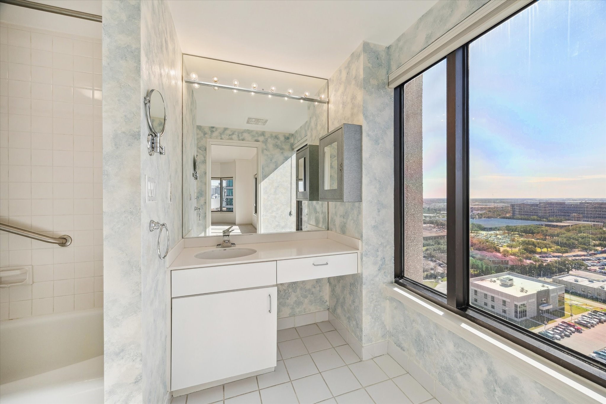 2001 Holcombe Boulevard, Unit 1801 Houston, TX 77030 - Photo 12 of 47 a bathroom with a sink and a large mirror