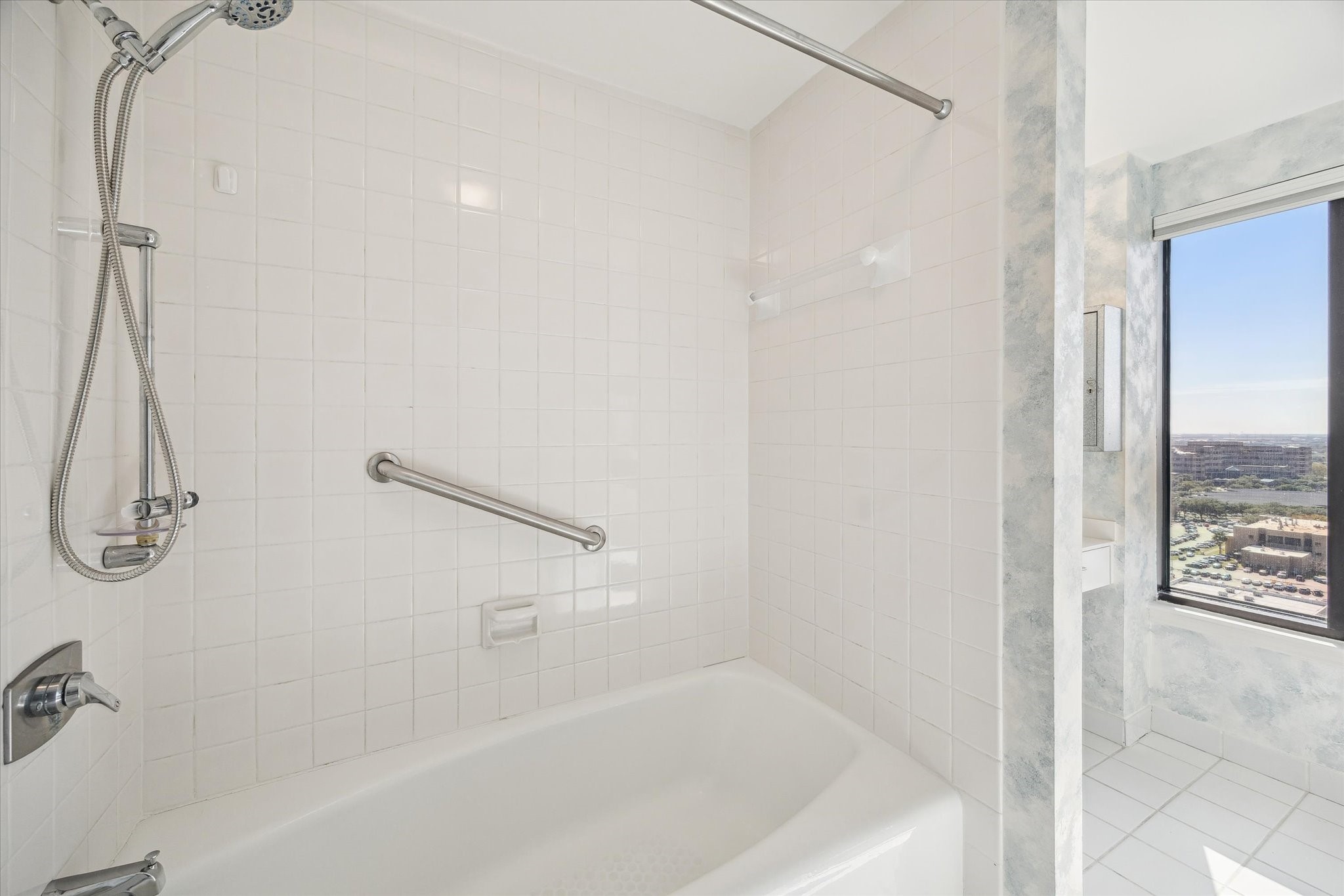 2001 Holcombe Boulevard, Unit 1801 Houston, TX 77030 - Photo 13 of 47 a bathroom with a bath tub with a shower
