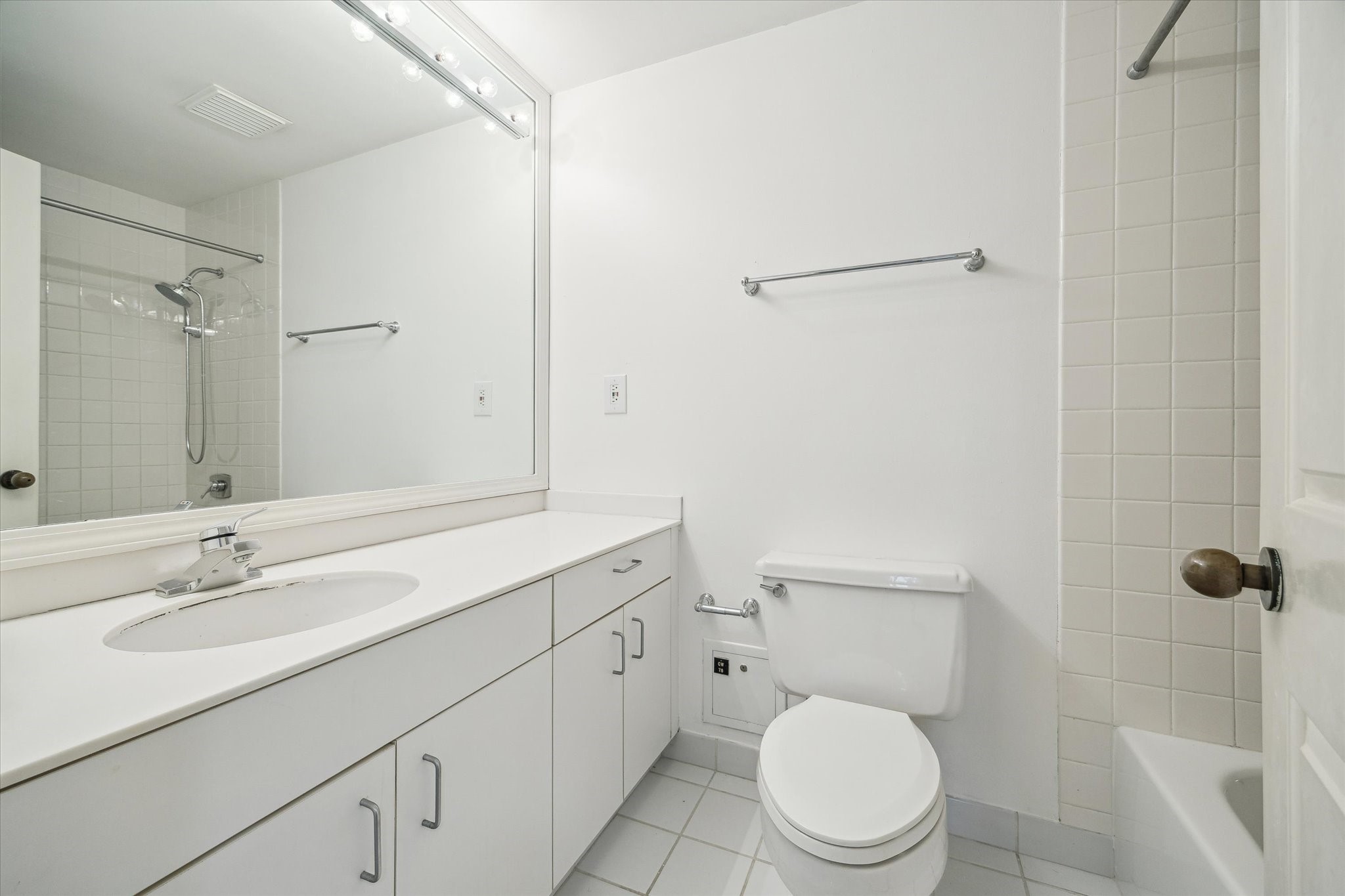 2001 Holcombe Boulevard, Unit 1801 Houston, TX 77030 - Photo 15 of 47 a bathroom with a toilet a sink a mirror and vanity