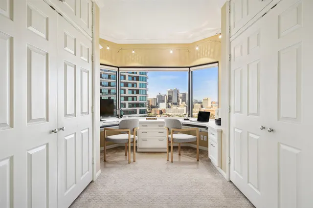 a view of a bedroom with table and chair
