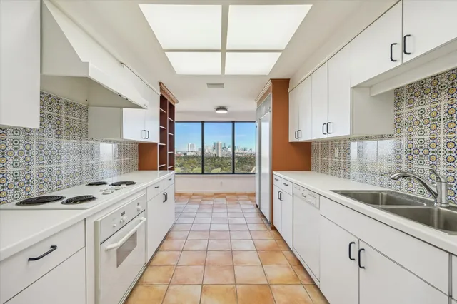 a kitchen with stainless steel appliances granite countertop a sink and stove