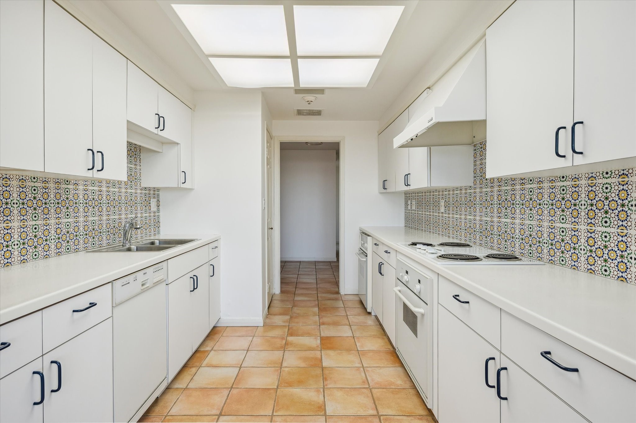2001 Holcombe Boulevard, Unit 1801 Houston, TX 77030 - Photo 9 of 47 a kitchen with stainless steel appliances granite countertop a sink and stove