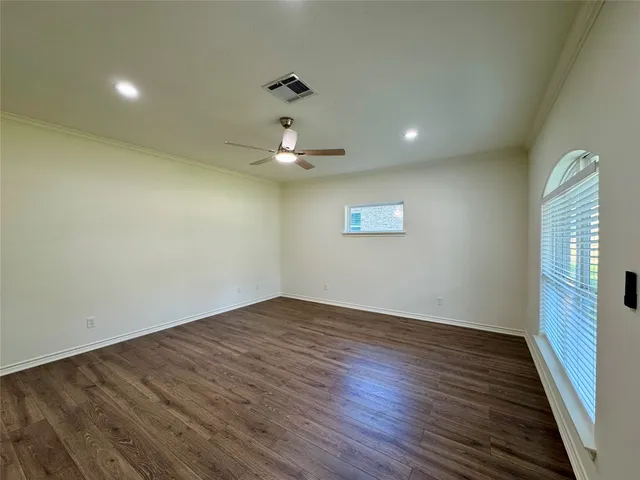 a view of a room with wooden floor and window