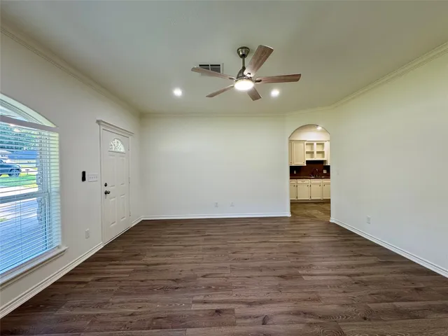 wooden floor in an empty room with a window
