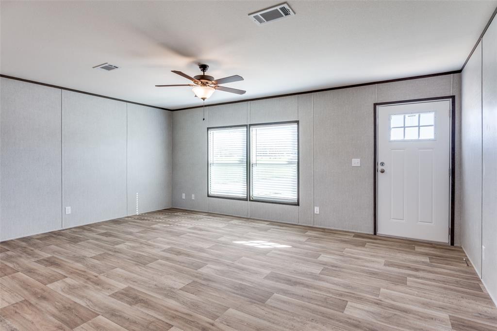 175 Cedar Drive Azle, TX 76020 - Photo 7 of 25 a view of empty room with wooden floor and fan