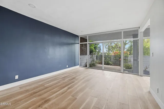 a view of an empty room with closet and a window