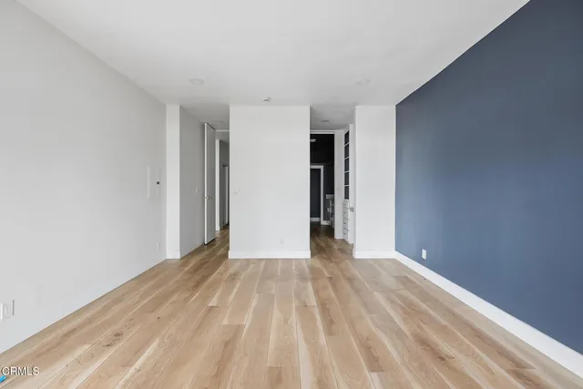 a view of an empty room with wooden floor