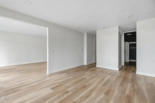 a view of walk in closet with empty racks